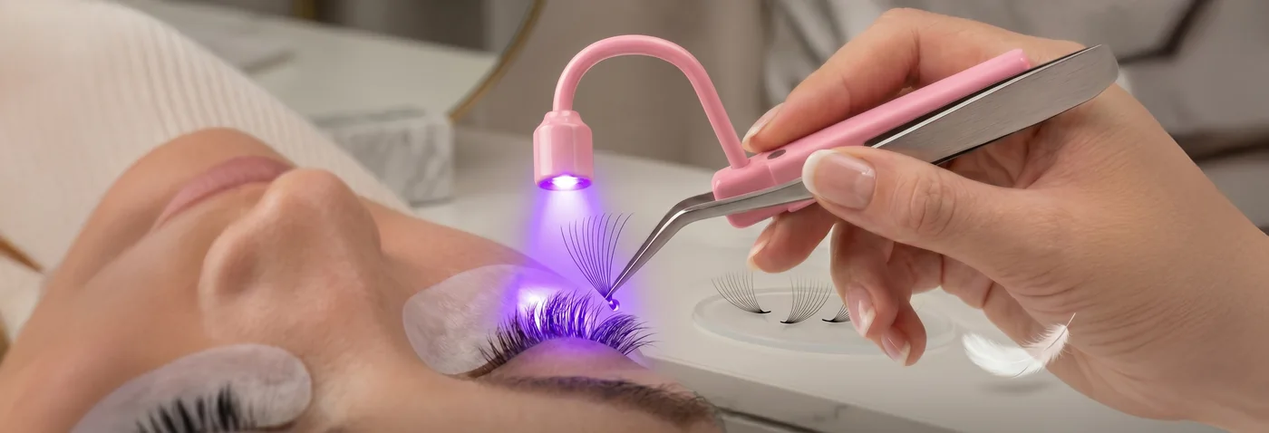 Close-up of the UV beam setting a lash fan on the natural lash line